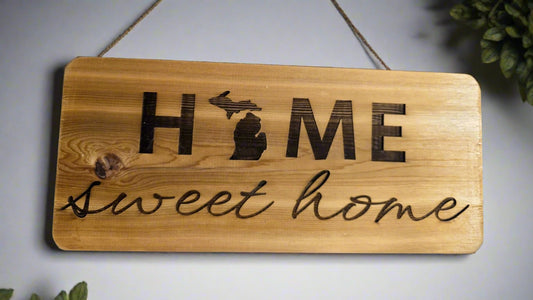 Wooden sign with 'HOME sweet home' engraving on a wood surface. 